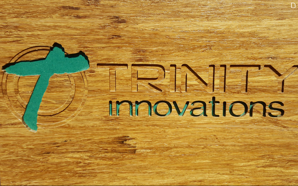 Trinity Innovations logo on a wooden background
